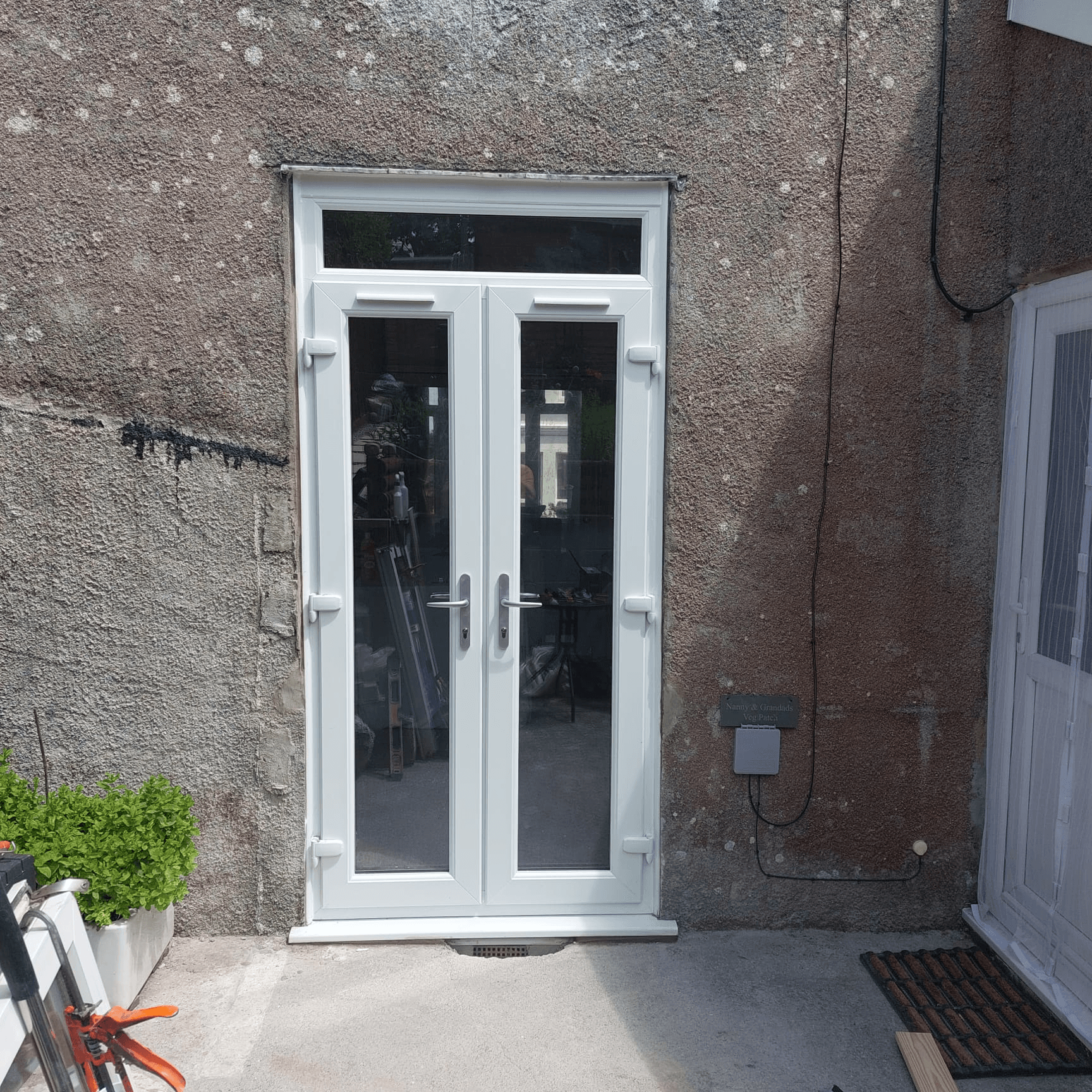 White UPVC french doors with transom fitted